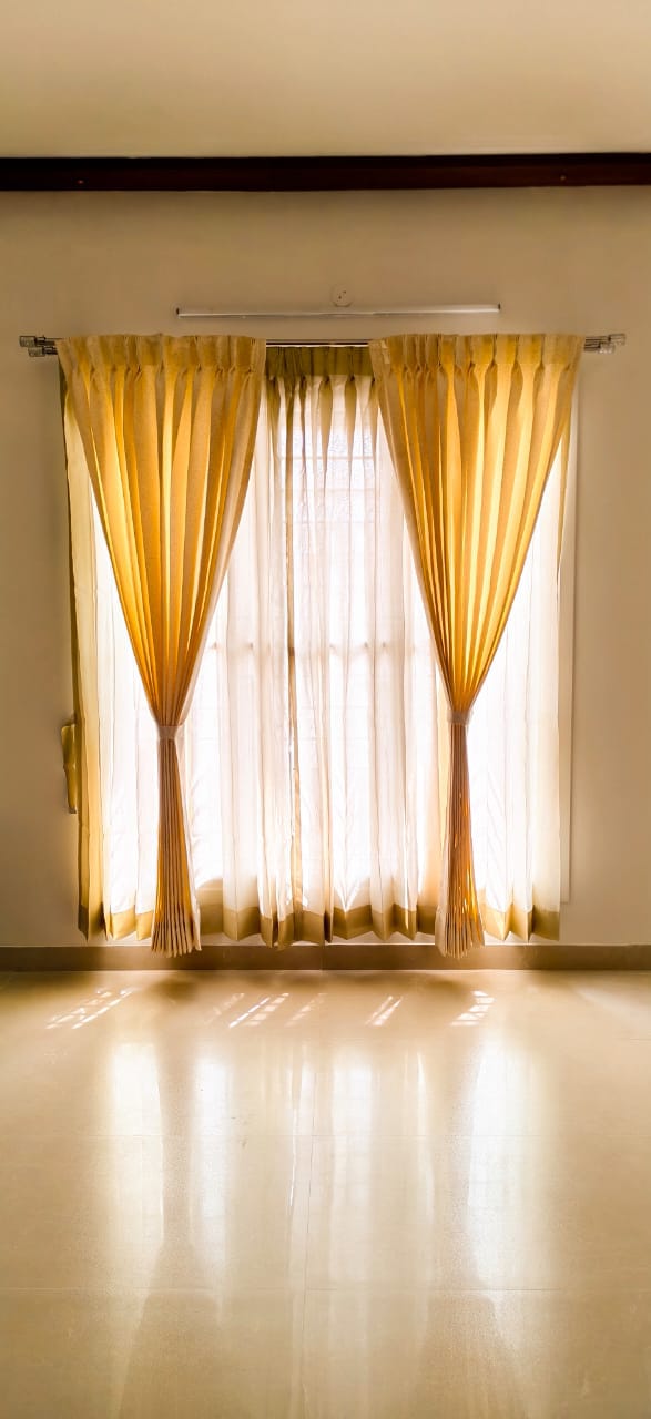 Gold curtains, tied back in daylight