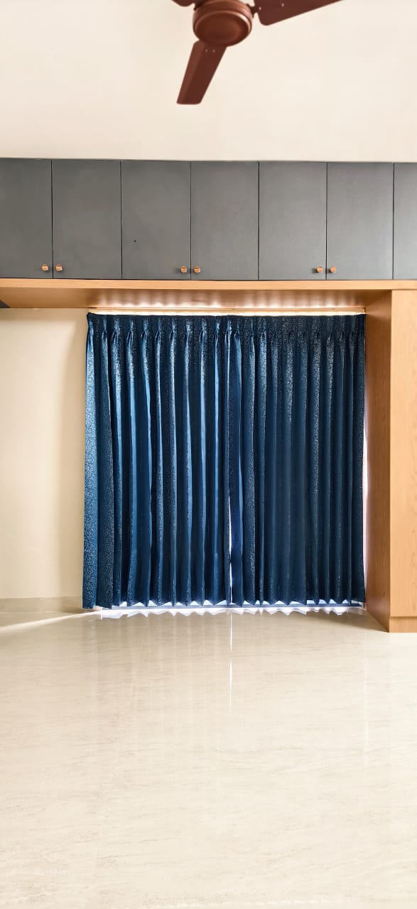 Navy curtains under a kitchen cabinet