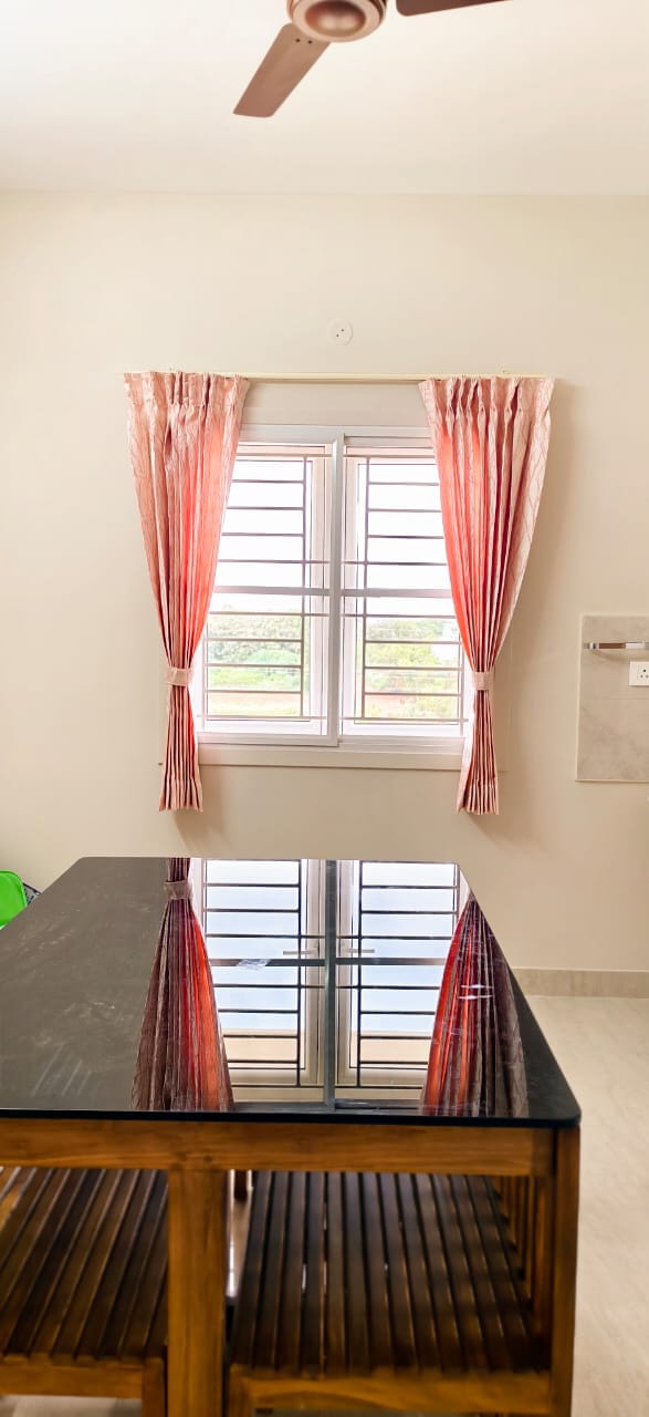 Pink curtains above a dining table