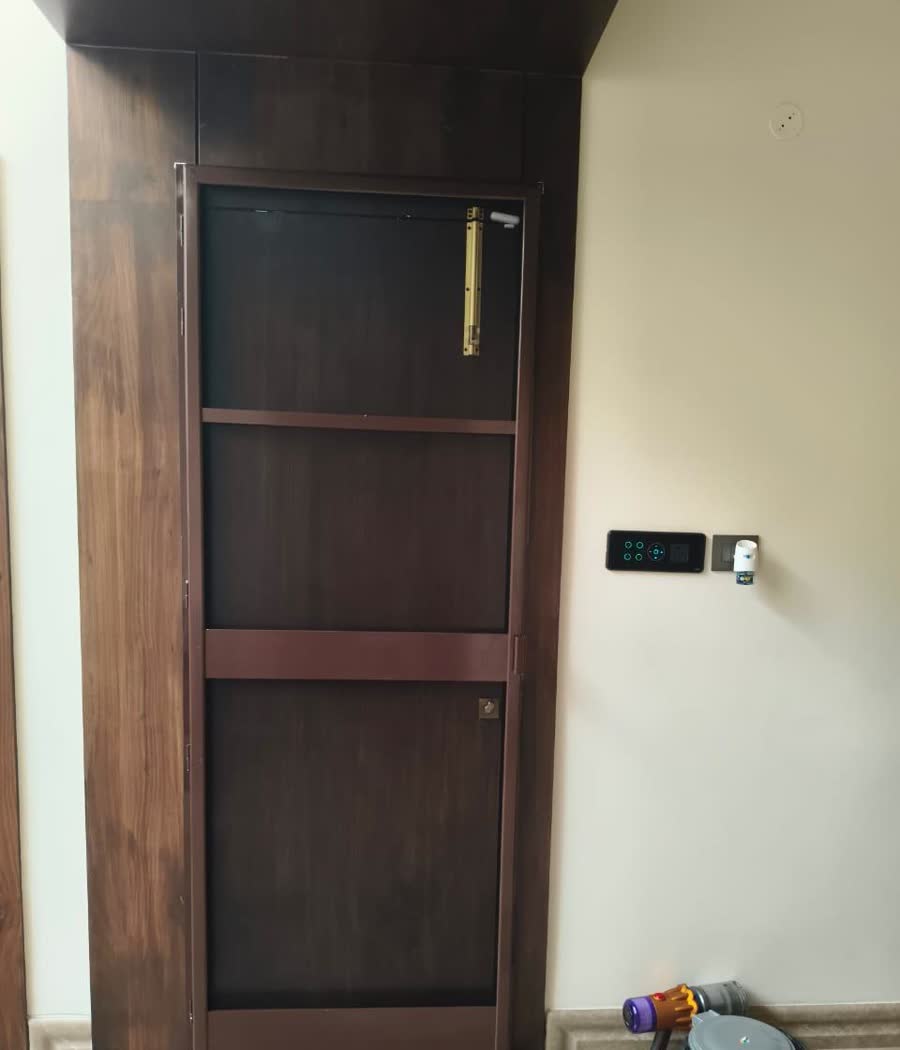 A net door finished to match dark walnut panelling