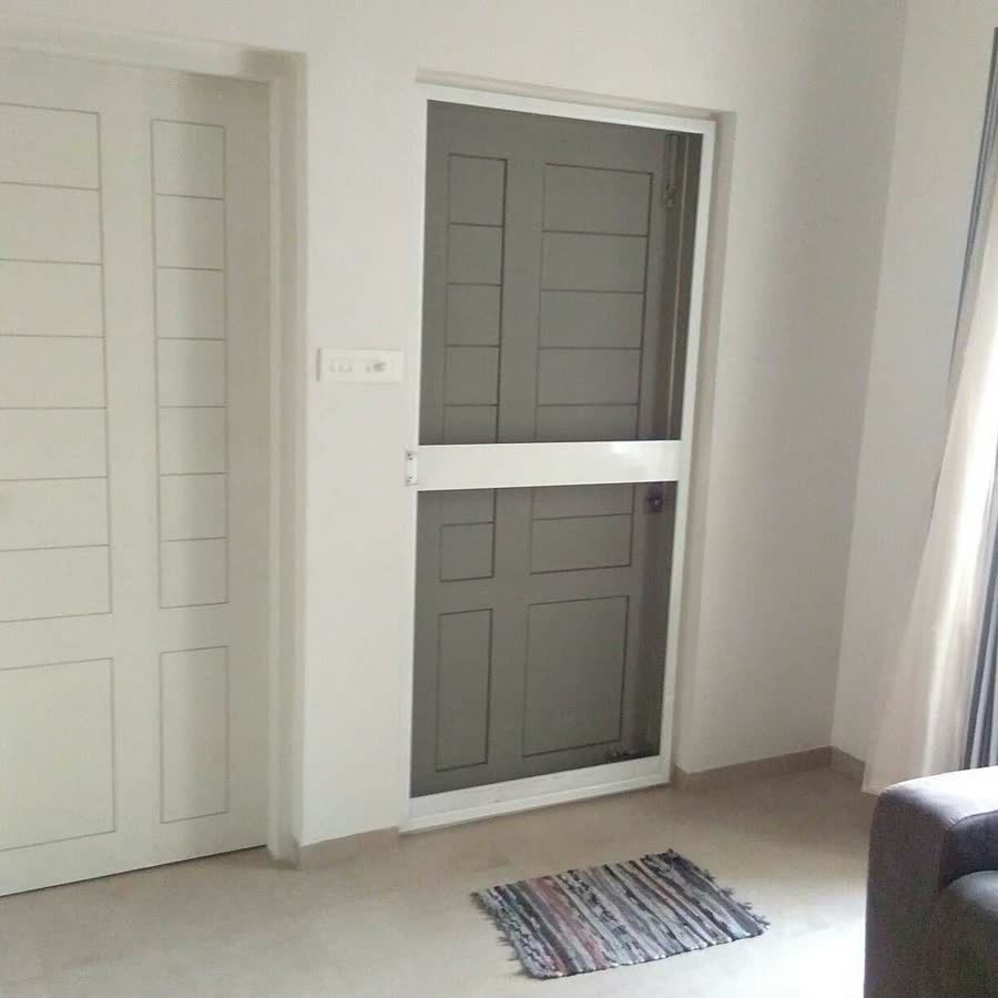 A white-framed net door in a modern home