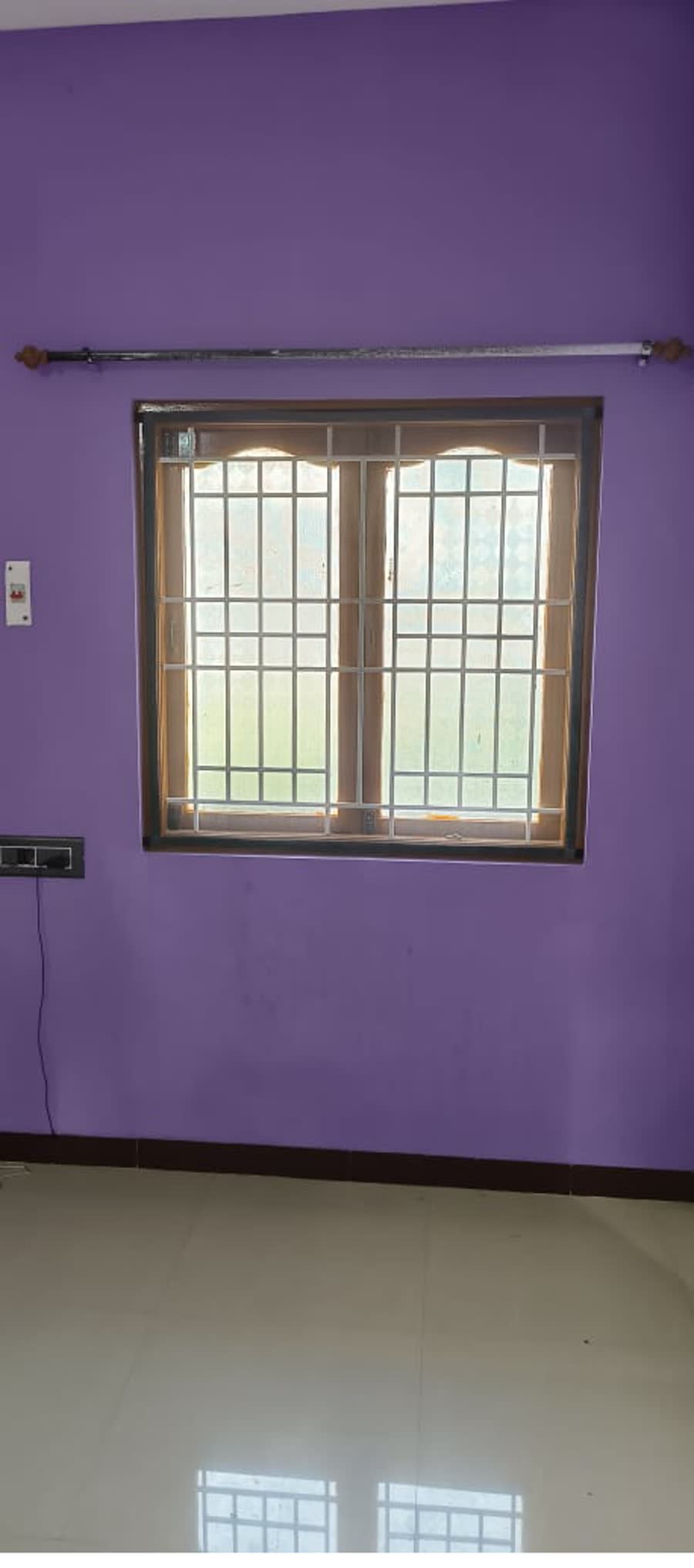 A velcro mosquito net fitted to a bedroom window