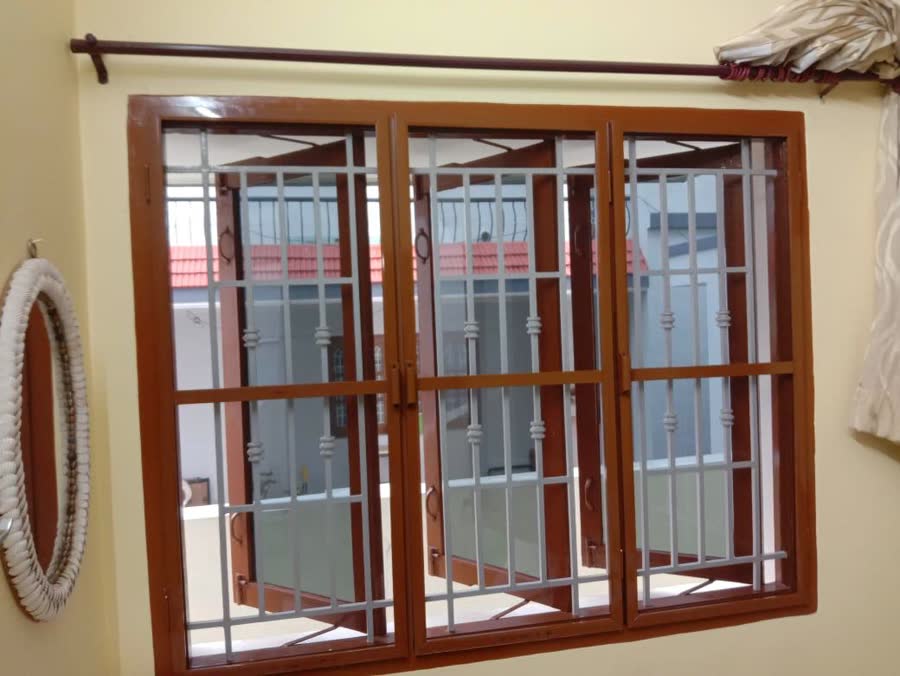 Teak frames on a three-panel window
